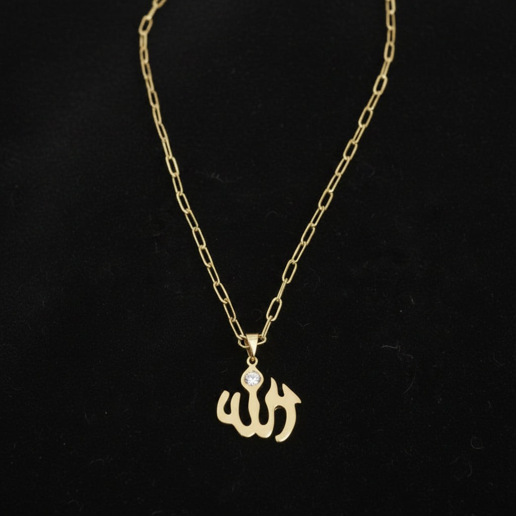 Gold necklace with a pendant on a black background